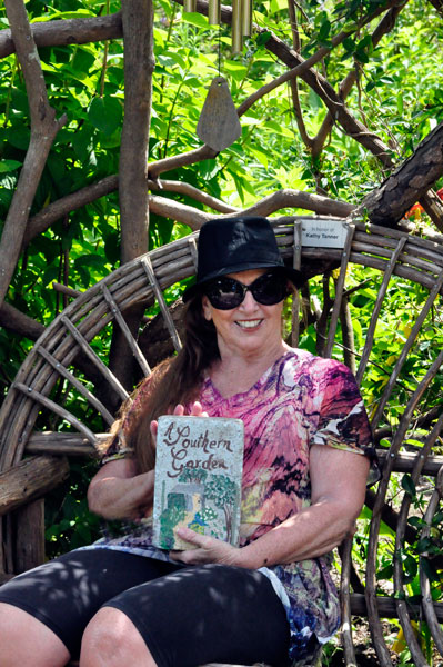 Karen Duquette holding a painted rock book